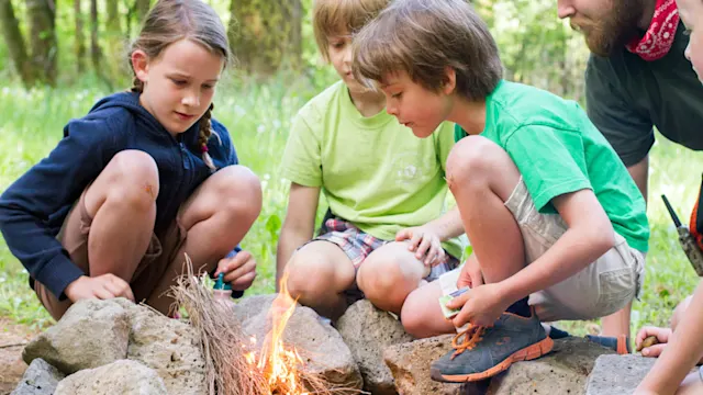 Homeschool students around a campfire