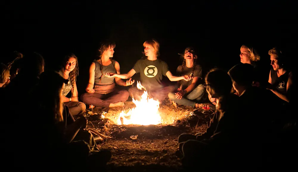 Trackers Guide telling stories at the campfire